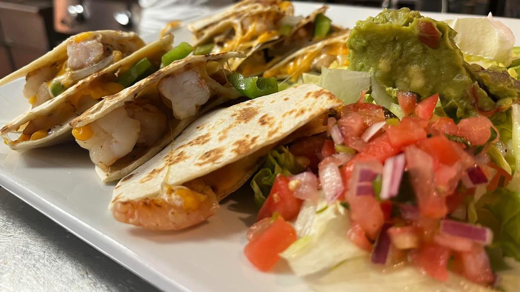 Shrimp Quesadilla · Grilled flour tortillas with Monterrey jack cheese, mushrooms, green peppers, and sauteed onions. Served with sour cream, pico de gallo, and guacamole.