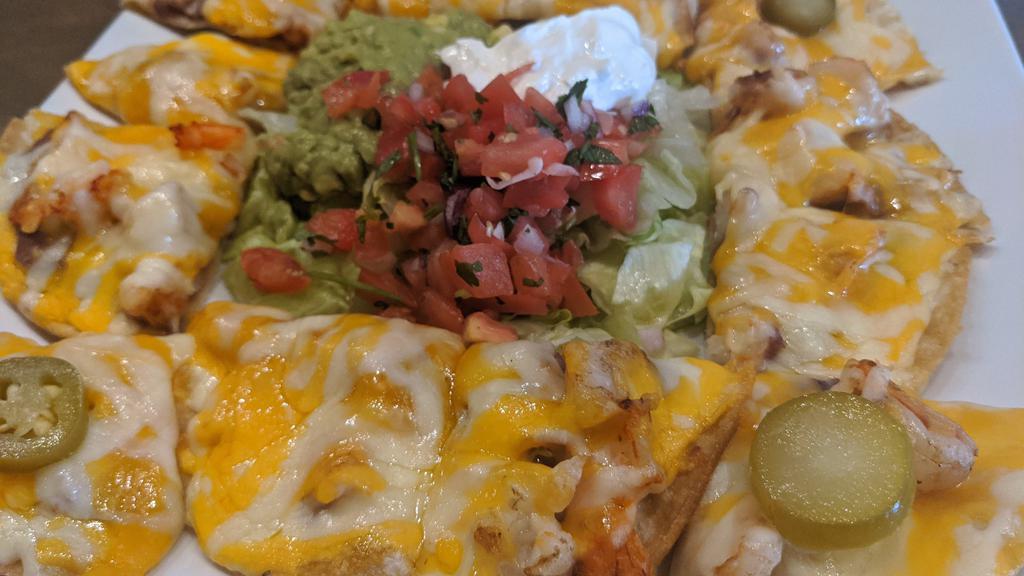 Shrimp Nacho · Served with melted cheese, beans, jalapenos, and a side of guacamole, sour cream, and pico de gallo.