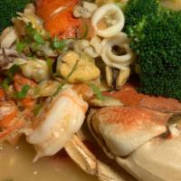 Large Seafood Soup · Half a lobster, half a crab, shrimp, in a delicious broth. Comes with rice & tortilla.