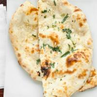 Garlic Naan · Hand-stretched leavened soft flatbread cooked in tandoor.