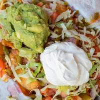 Nacho Fries · tomatoes, jalapenos, chopped onion, guacamole, lettuce, cheddar jack cheese, sour cream