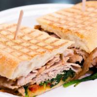 Roast Pork Italian Panini · thinly sliced roast pork with sauteed spinach, provolone, and roasted peppers served on ciab...