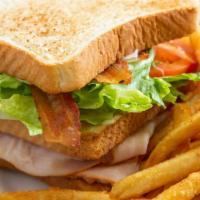 Turkey Club Sandwich · Lettuce, tomato, bacon, and mayonnaise on white or wheat toasted bread with choice of  fries...