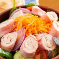 Chefs Salad · Salad greens, tomatoes, peppers, carrots, cucumbers, and red onions topped with smoked turke...