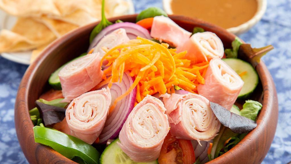 Chefs Salad · Salad greens, tomatoes, peppers, carrots, cucumbers, and red onions topped with smoked turkey, ham, and mozzarella cheese. Served with your choice of dressing.