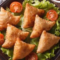 Samosa Veggie Appetizers · Cumin flavored potatoes and peas wrapped in flakey pastry.