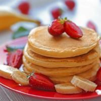 Strawberry & Banana Pancakes · Plain airy pancakes with fresh bananas and strawberries, served with butter, whipped cream a...