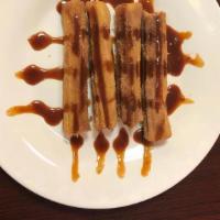 Churros With Cajeta · Fried dough pastry with thickened caramel sauce