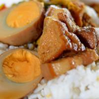 Khai Palo On Rice · Jasmine rice w/ soy egg, pork belly and tofu.