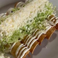 Tacos Dorados (5 Pieces) · Pulled chicken and Oaxaca cheese rolled in a corn tortilla and deep-fried topped with lettuc...