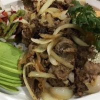 Beef Encebollado · Top round beef sautéed with Spanish onions and served with house salad and guacamole.