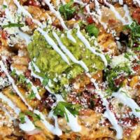 Nachos · White corn tortilla chips | queso fundido | pinto beans | fresh jalapeños | guacamole | pico...
