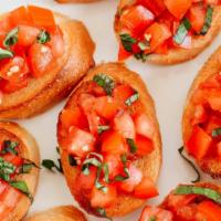 Bruschetta · A traditional topping of Roma tomatoes, fresh basil & extra virgin olive oil. Served on fres...