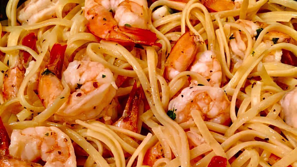 Linguine Agli Scampi · Gulf shrimp tossed in extra virgin olive oil with fresh diced tomatoes, garlic, white wine & parsley with a hint of marinara.
