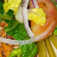 Shawermah Chicken · Chicken, pita bread, sliced tomato, garlic sauce, lettuce, onions, and pickled wild cucumber