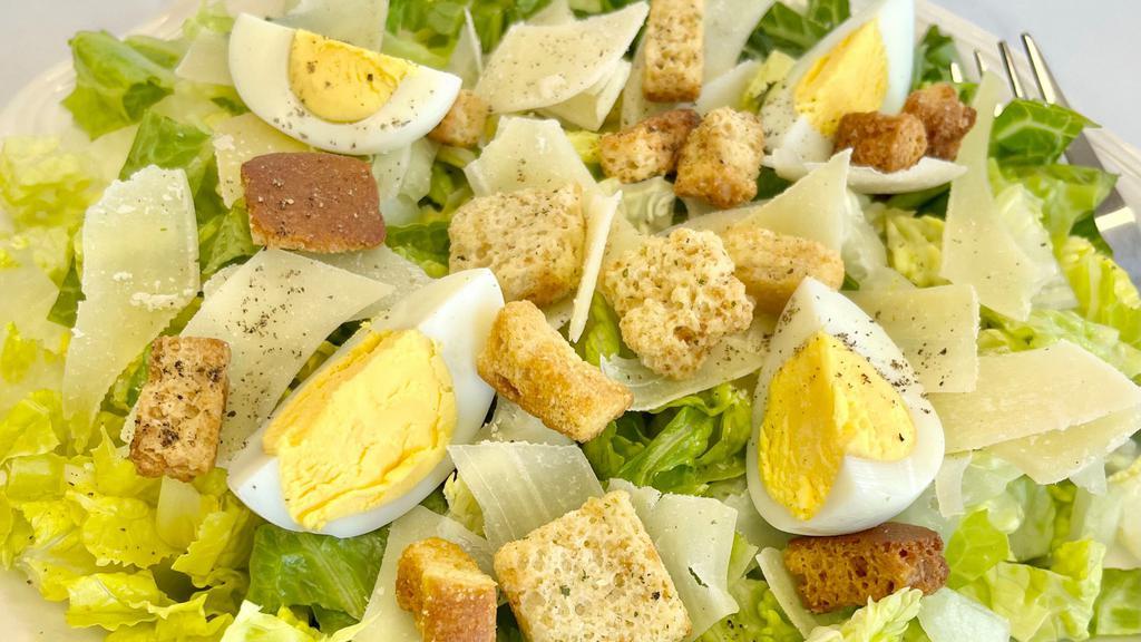 Ultimate Caesar Salad · Crisp romaine lettuce, garlic croutons, grated parmesan cheese and caesar dressing.
