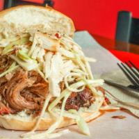 Pulled Pork Sandwich · Carolina Style Pulled Pork.   Served on Fresh Pub Roll, w Topping of House Slaw (optional), ...