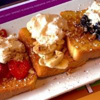 French Riviera · Three pieces of French toast overstuffed to the max with strawberries, bananas, blueberries,...