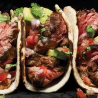 Carne Asada Taco · Tortilla topped and folded with a filling of thin slices of steak, red onion, cilantro.