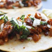 Adobada / Pork (Tacos) · Tortilla topped and folded with a filling pork, red onion, cilantro.