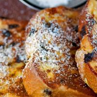 Chocolate Chip French Toast · Three slices of thick, egg-washed challah bread topped with chocolate chips and served with ...