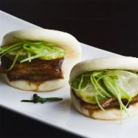 Pork Belly Bao Bun · Scallion and pickled cucumber.