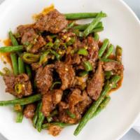 Yuen-Yang Beef · Hot and spicy. Sliced beef sautéed with hot pepper sauce, served on a bed of string beans.
