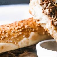 French Dip · Thinly sliced top round, topped with melted aged provolone, on a toasted garlic Italian roll...