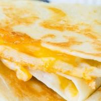 Quesadilla · Grilled flour tortilla stuffed with cheddar jack cheese, served with side of sour cream and ...