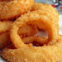 Onion Rings · Crispy onion rings piled high and served with jalapeño ranch dressing.