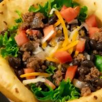 Taco Salad · Seasoned ground beef, shredded lettuce, cheddar jack cheese, diced tomatoes, black olives an...