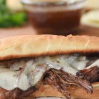 French Dip · Shaved ribeye, caramelized onions, provolone, toasted baguette, Au Jus, horseradish sauce.