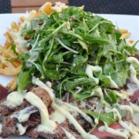 Steak Frites · Grilled 14oz ribeye, truffle fries, arugula & parmesan salad, truffle aioli