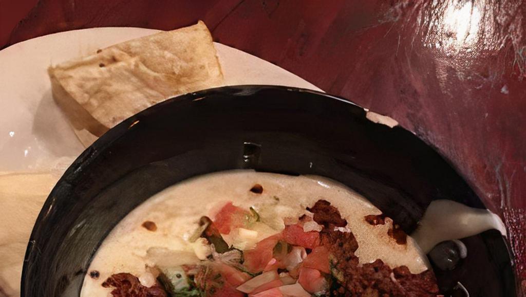 Queso Fundido · Melted chihuahua cheese served with your choice of chips or tortillas.