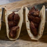 Tacos De Asada · Choice of four corn or three flour tortillas, stuffed with tender steak strips or grilled ch...