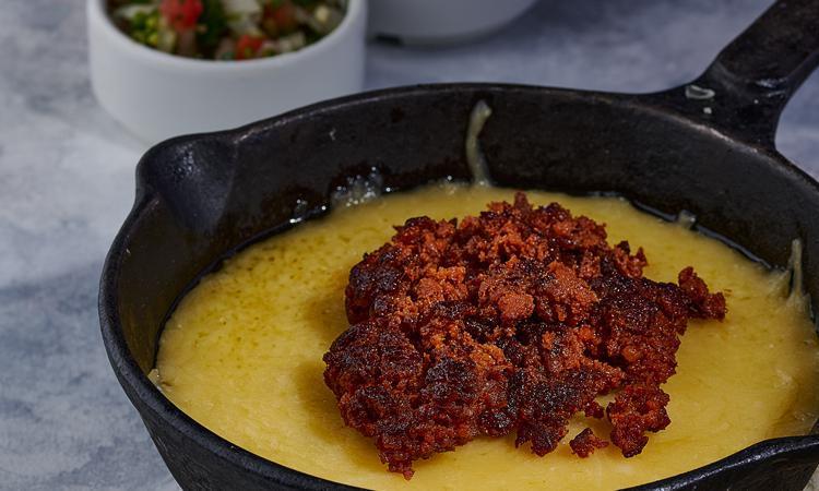 Queso Fundido · Sizzling, melted Chihuahua cheese with your choice of Mexico’s famous chorizo sausage or traditional mild roasted poblano peppers strips, served with three flour tortillas or four corn tortillas and pico de gallo.