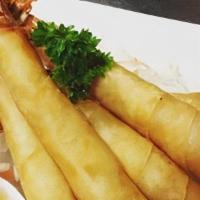 Shrimp In Blanket · Marinated shrimp in egg-roll skin, deep fried and served with homemade plum sauce.