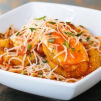 Crispy Chicken Parm · marinara, mozzarella, Parmigiano-Reggiano, fresh basil chiffonade, over capellini pasta.