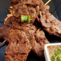 Crying Tiger · 2 skewers of  Thai/Laotian style beef served with rice and salad