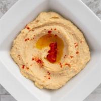 Hummus · Our house recipe. Topped with Harrissa and drizzled with extra virgin olive oil
