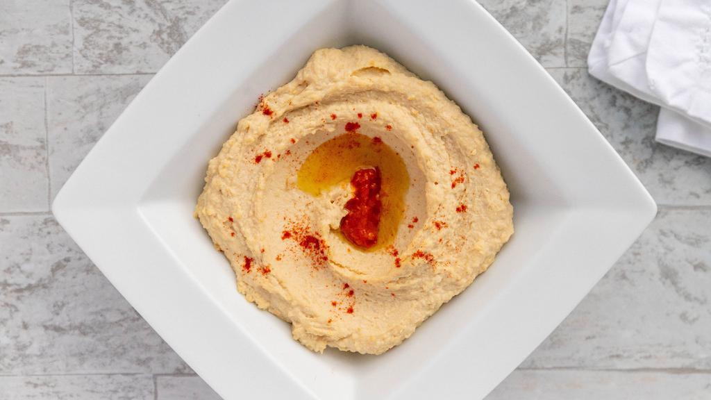 Hummus · Our house recipe. Topped with Harrissa and drizzled with extra virgin olive oil