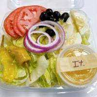 Garden Salad · With iceberg lettuce, tomatoes, cucumbers, red onion, black olives, pepperoncini's, pita bre...