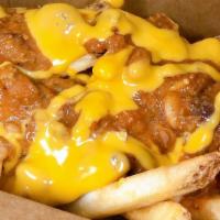 Chili Cheese Fries · Golden crispy french fries topped with beef and bean chili, and nacho cheese sauce.
