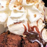 Brownie Sundae · Served with hot fudge, fresh whipped cream, walnuts, cherry, and a warmed chocolate chip bro...