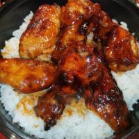 Buffalo Wings And White Rice Bowl · Our white rice bowl is topped with 5 pieces of our baked buffalo wing sections that are toss...