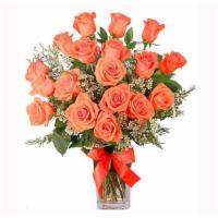 Orange Admiration Rose Arrangement · Roses have never looked so good! With 18 glorious coral roses, graceful white waxflower, and...