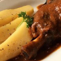 Baked Lamb · lamb shank braised in a tomato sauce served with roasted potatoes.