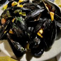 Mussels Chablis · sautéed with garlic, tomato, scallion, olives and wine served with garlic bread.