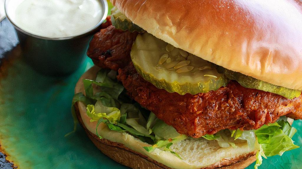Nashville Hot Fried Chicken Sandwich · Sweet and firey Nashville hot style chicken. 4 ounces of all-natural antibiotic free chicken breast battered, fried, and coated in honey butter; served with pickles, mayo, and lettuce on a brioche bun.