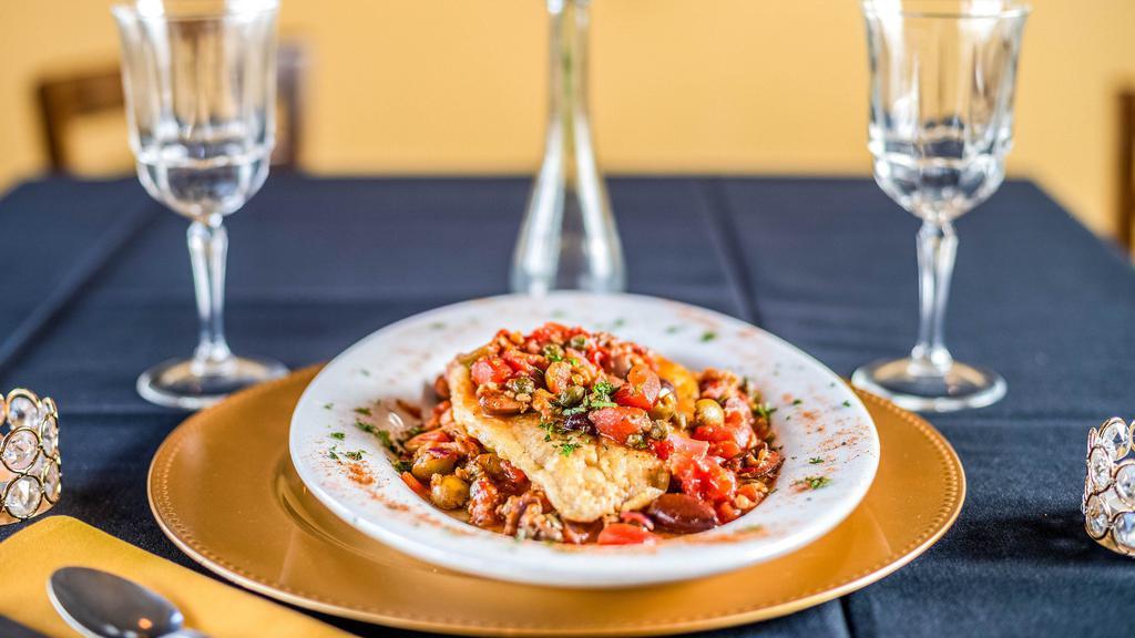 Mediterranean Flounder  · Served with olives, roasted peppers, clam, and capers in a pomodoro sauce. Accompanied with 1 side.